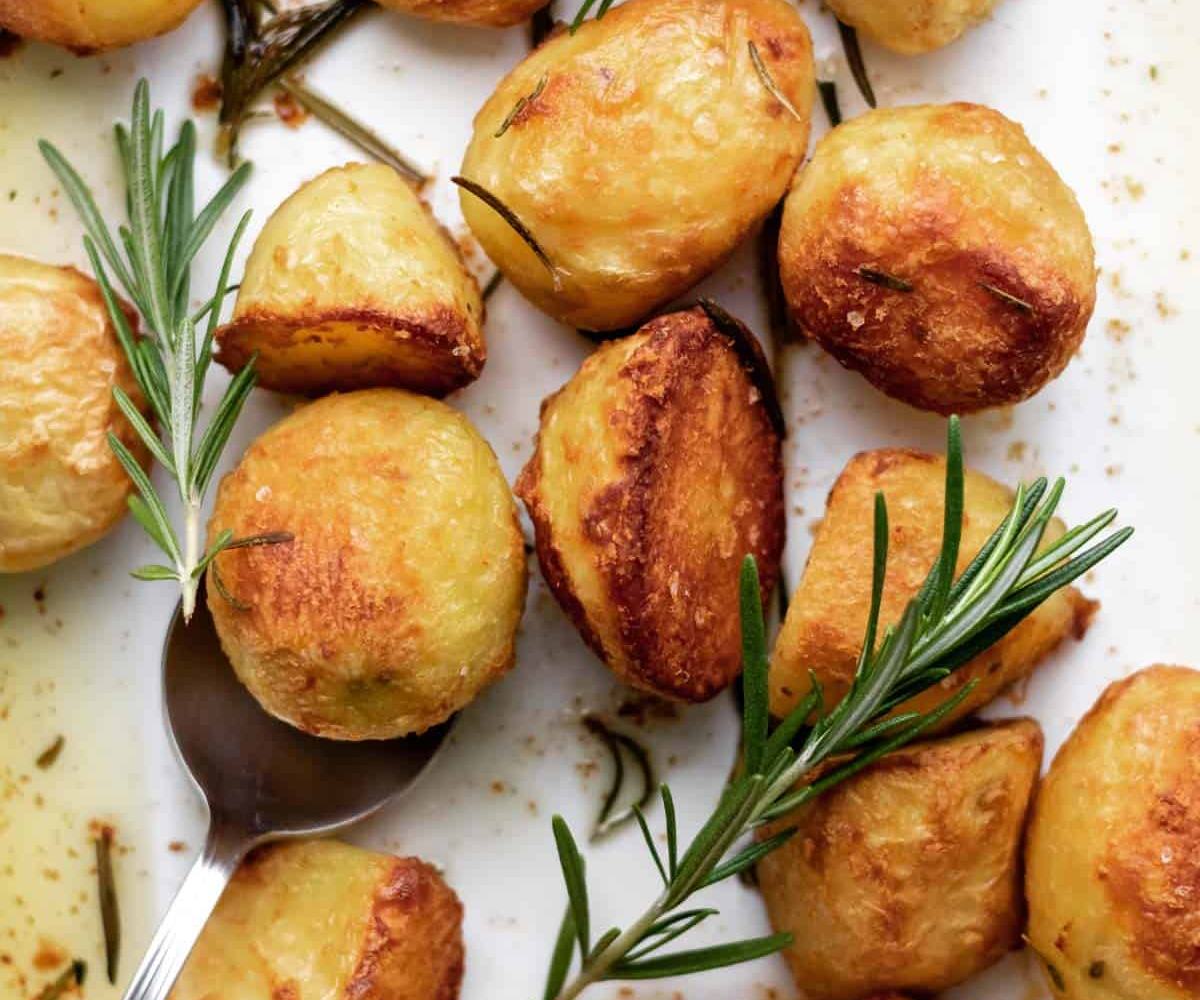 Golden parboiled potatoes roasted with fresh rosemary until perfectly tender inside and deeply caramelized with crispy, thick outside.